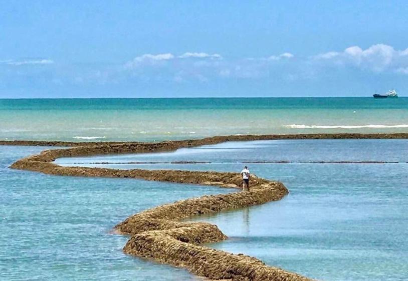 a person walking on an island in the ocean at Chipiona Center in Chipiona