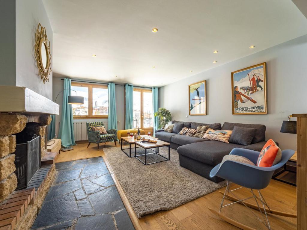 a living room with a couch and a fireplace at Duplex rénové à Tignes · Accès direct pistes · Cheminée · WIFI · Animaux acceptés - FR-1-502-482 in Tignes