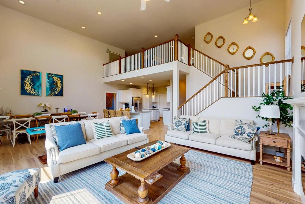 a living room with two couches and a table at Bay Dreams --- 31415 Erie Ave in Ocean View