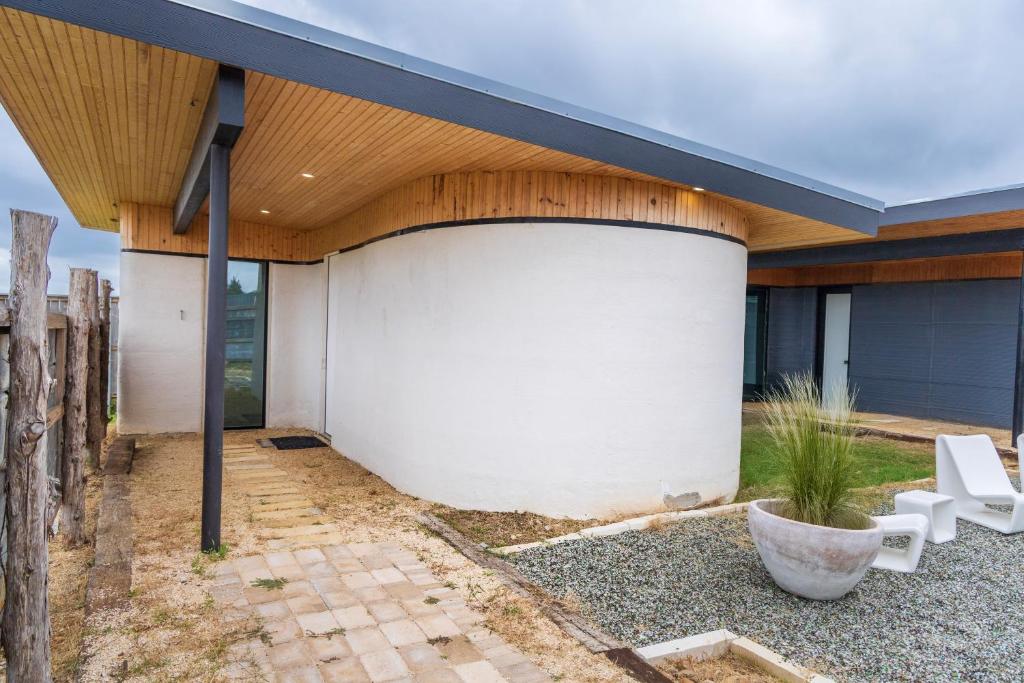 an external view of a house with a wooden roof at Casita 1 at The Halles Artisan Venue in Round Top