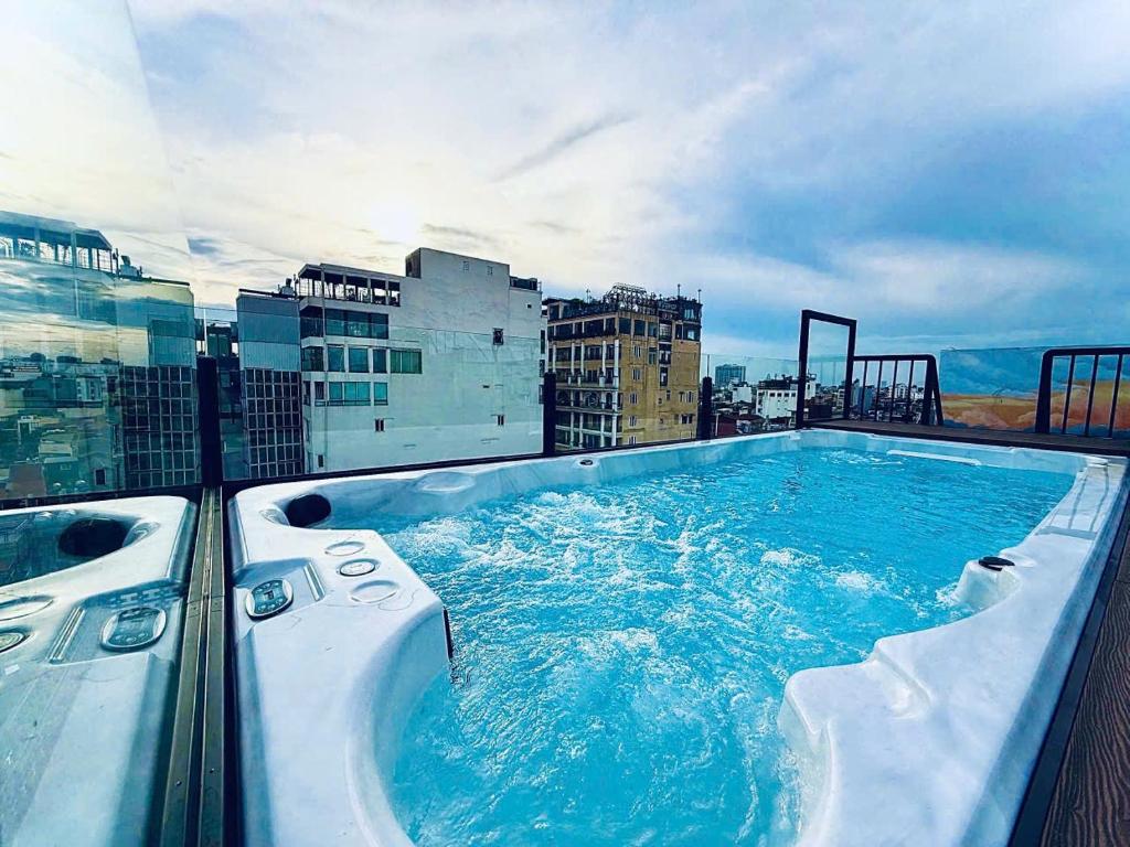 a large swimming pool on top of a building at Lucien Hanoi Lakeside Hotel & Rooftop in Hanoi