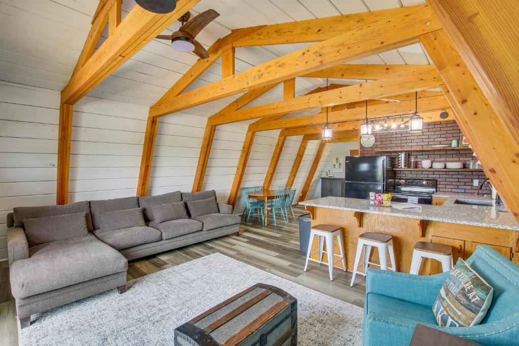 a living room with a couch and a bar in a cabin at Garden City Home with Fire Pit Walk to Bear Lake! in Garden City