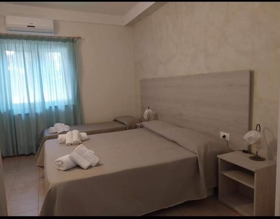 a bedroom with two beds with towels on them at San Domenico Village in Fitili
