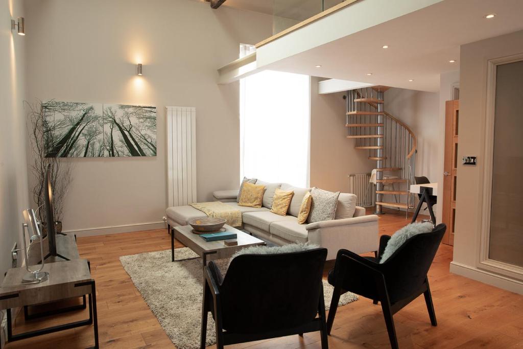 a living room with a couch and a table at Under new management- The old meeting hall in Holt
