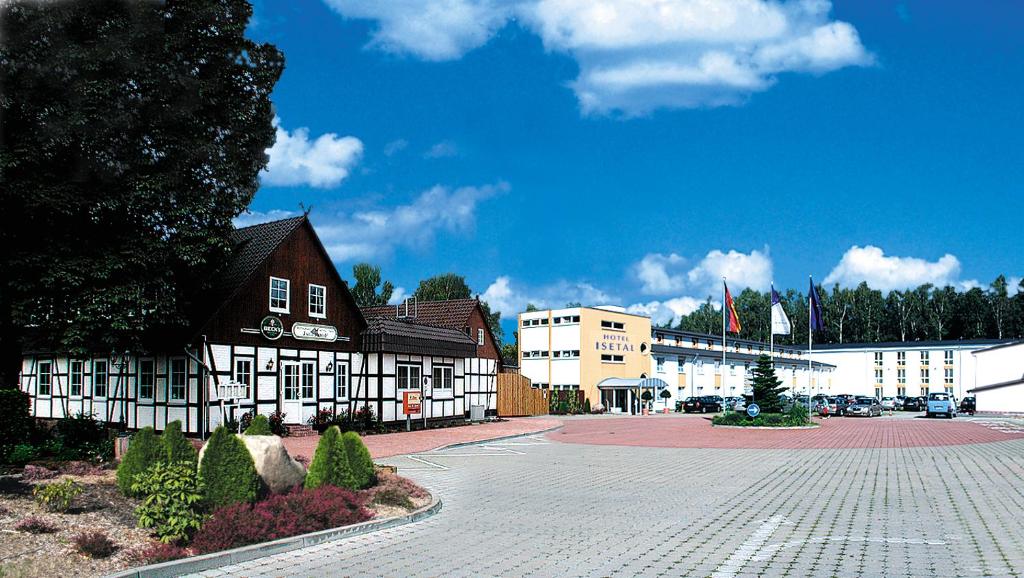 a cobblestone street in front of a building at Morada Hotel Isetal in Gifhorn