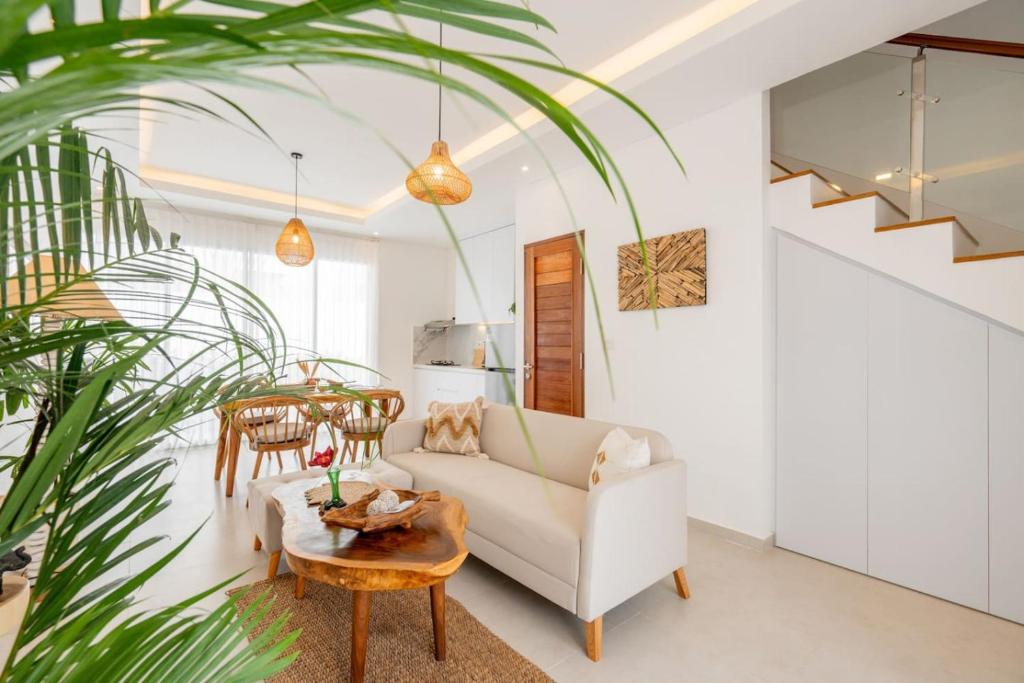 a living room with a couch and a table at Sunrise Bliss 2 in Dalung