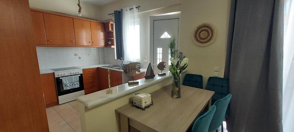 a kitchen with a table and chairs in a room at Harmony 3 in Artemida