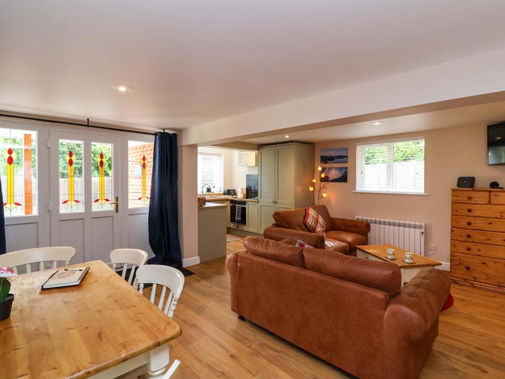 a living room with a couch and a table at Poddington Cottage in Salisbury
