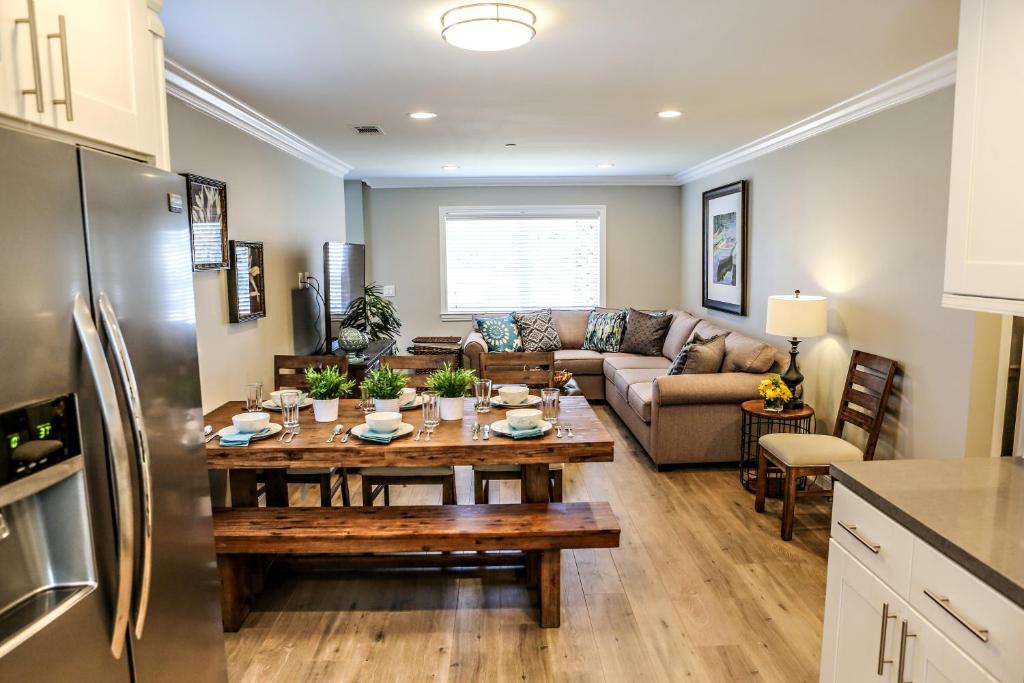 a kitchen and living room with a table and refrigerator at Adorable 3 Bedroom 2 Bath Home in Fullerton