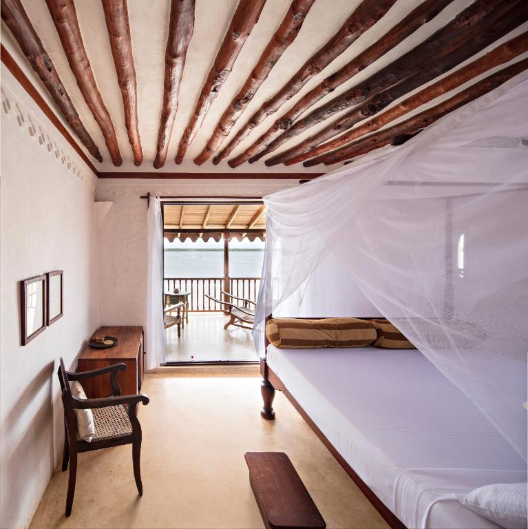 Postel nebo postele na pokoji v ubytování LAMU HOUSE