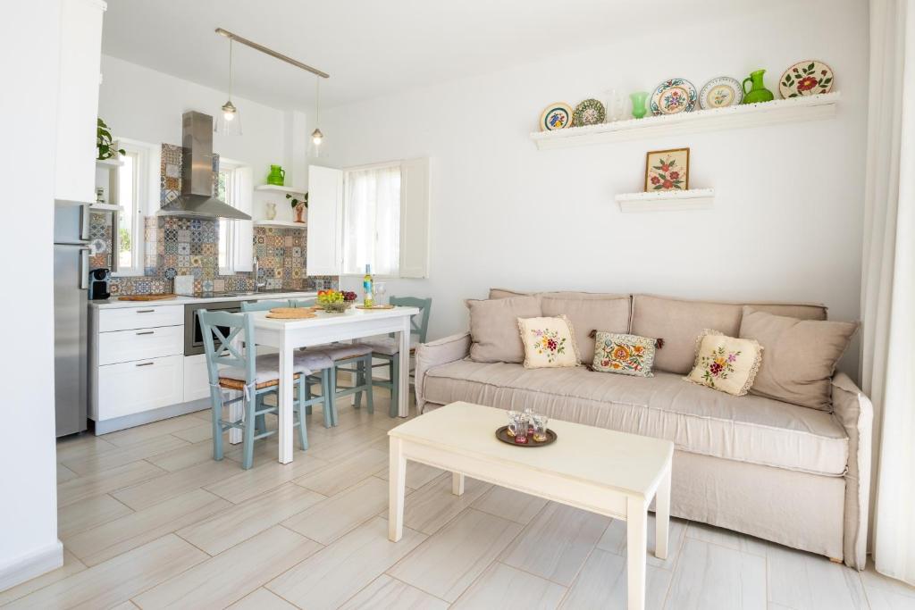 a living room and kitchen with a couch and a table at Silene Villas in Amoopi
