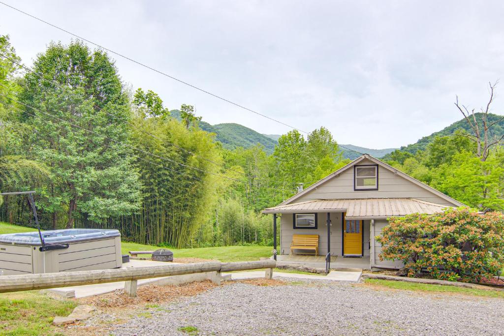 a small house with a fence and a yard at Private Hot Tub Cottage Near Hikes and Pigeon River in Canton