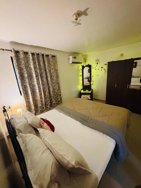 a bedroom with two beds and a window at Hidden Gem agonda in Agonda