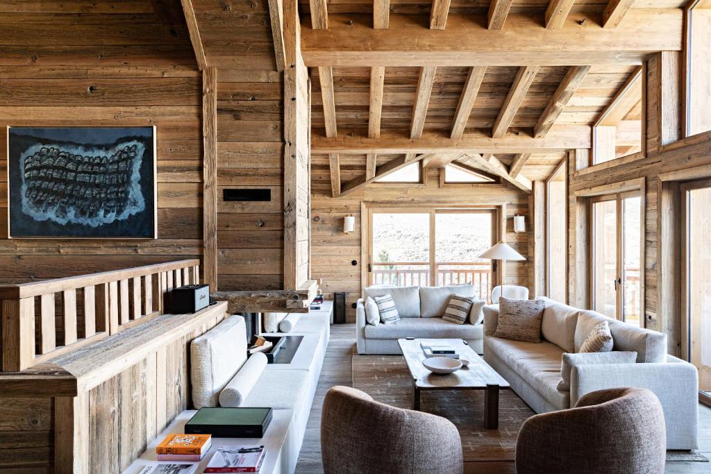 a living room with wooden walls and ceilings at Les Chalets de la Source 2 - Luxe - Skis aux pieds - 14 personnes in Saint-Martin-de-Belleville