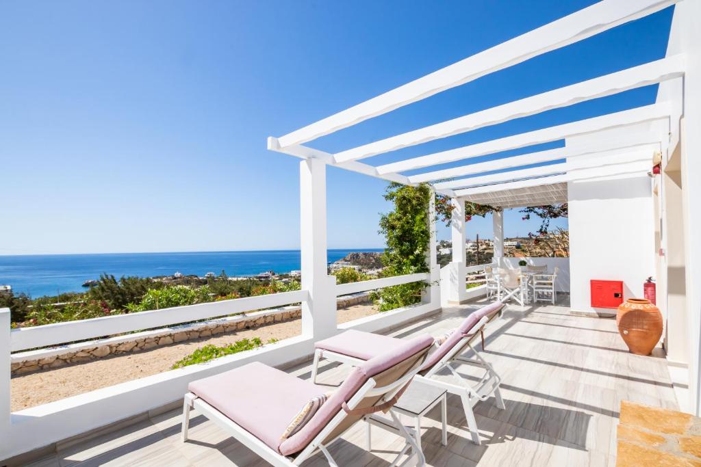 a deck with chairs and a view of the ocean at Silene Villas in Amoopi