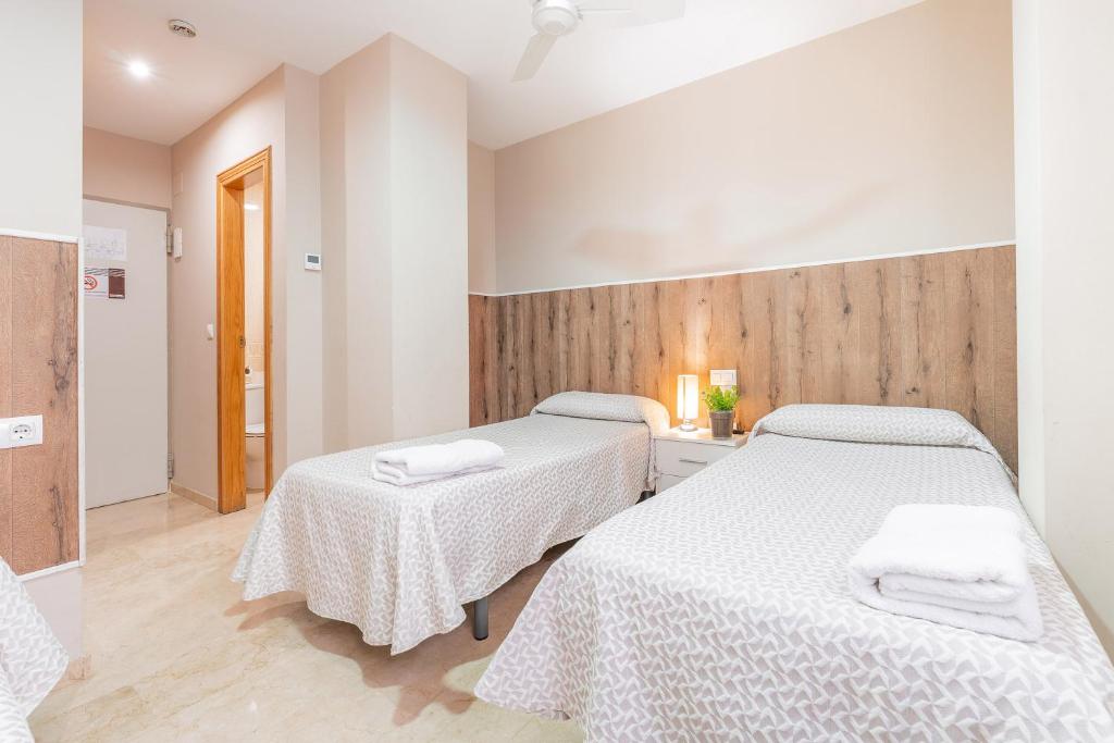Postel nebo postele na pokoji v ubytování Hostal El Bugar