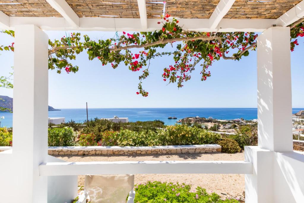 a view of the ocean from a white pergola at Silene Villas in Amoopi