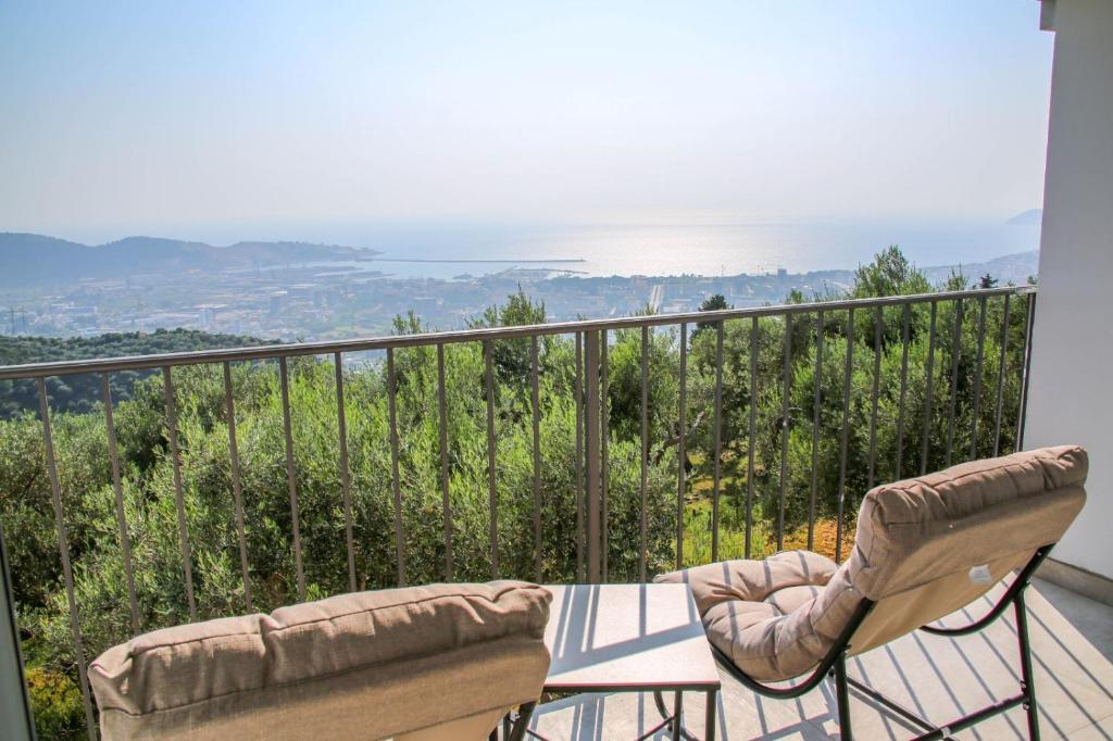 a balcony with two chairs and a table and a view at Olive Grove in Bar