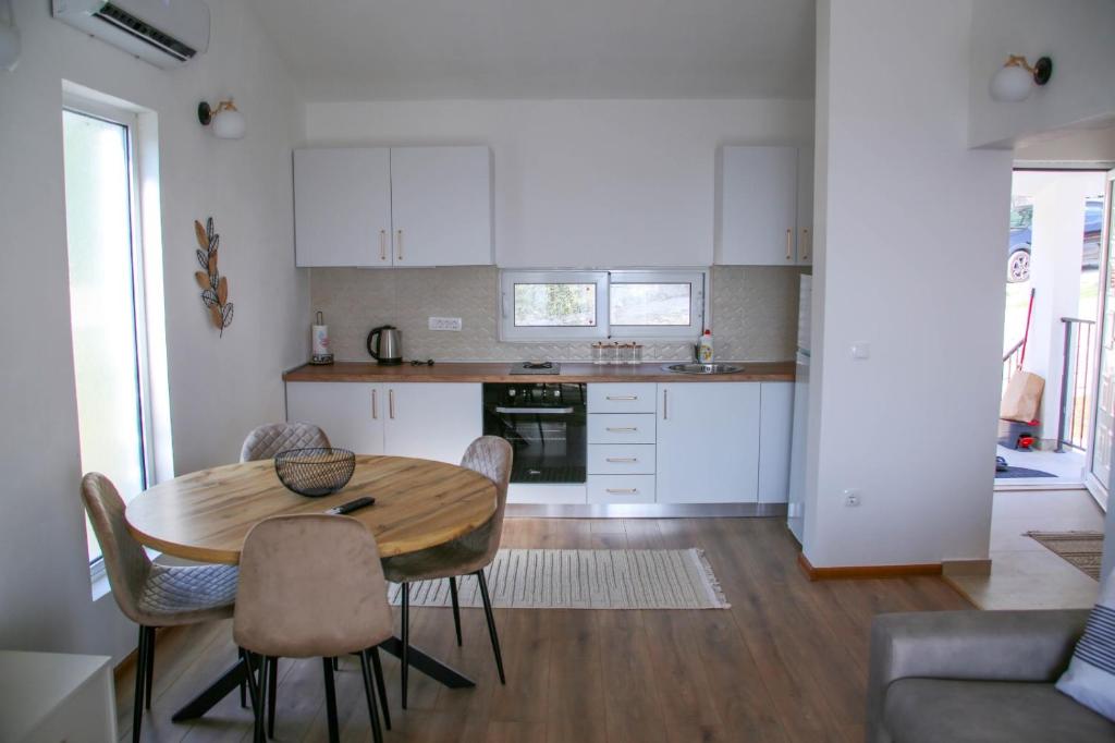 a kitchen with a table and chairs in a room at Olive Grove in Bar