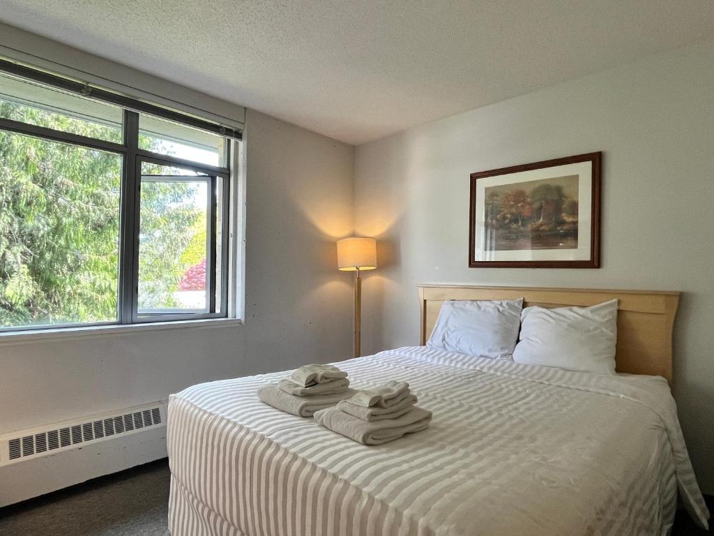 a bedroom with a bed with towels on it at Carey Centre on UBC campus in Vancouver