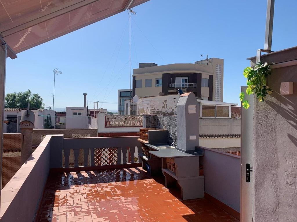 a balcony with a table on top of a building at Apartamento El Atardecer in El Perelló
