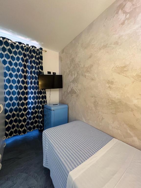 Letto o letti in una camera di Hotel Le Grazie
