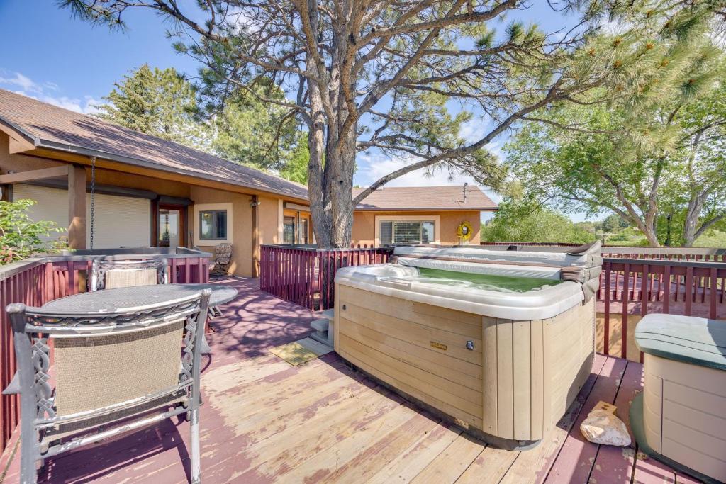 a hot tub on a deck next to a house at 3 Mi to Garden of the Gods Quiet Home with Hot Tub! in Colorado Springs