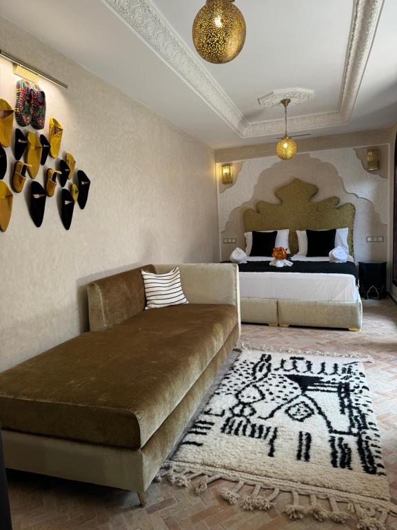 a living room with a couch and a bed at Riad M'Barka in Tangier