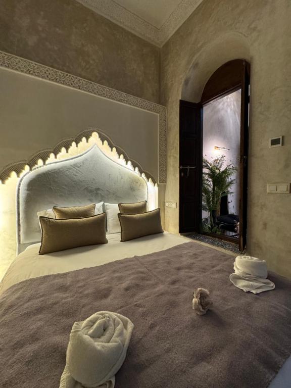 a bedroom with a large bed with a dog laying on it at Riad M'Barka in Tangier