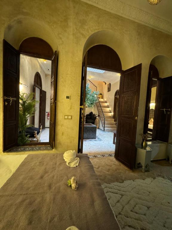 a room with a bed with a mirror and a hallway at Riad M'Barka in Tangier
