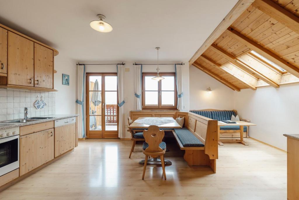 a kitchen with a table and a dining room at Hofer am Bach in Lagundo