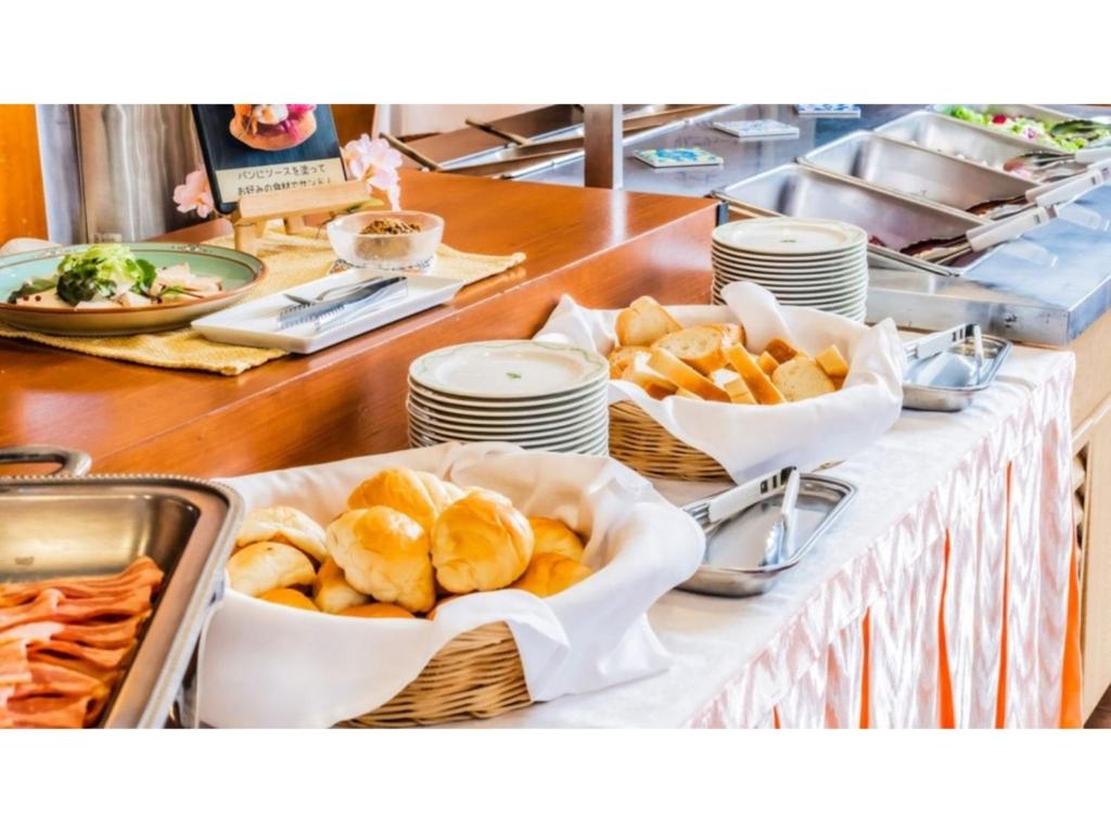 a buffet with baskets of food on a table at Ouka no sato La-Foret Shobara - Vacation STAY 49255v in Shōbara