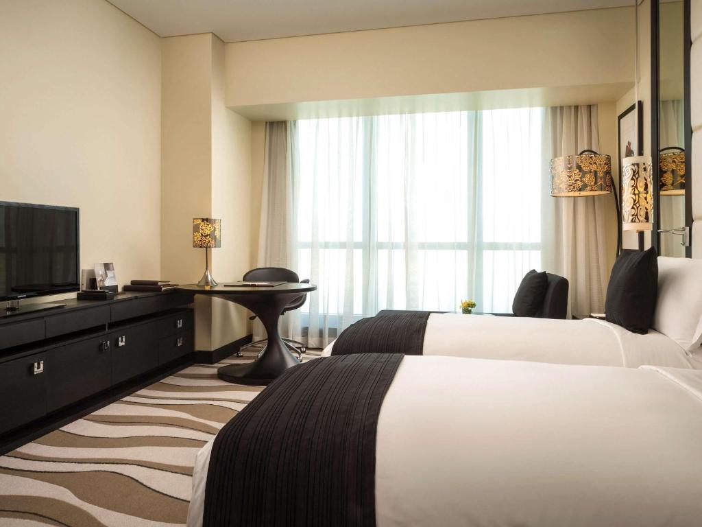 Postel nebo postele na pokoji v ubytování Sofitel Abu Dhabi Corniche