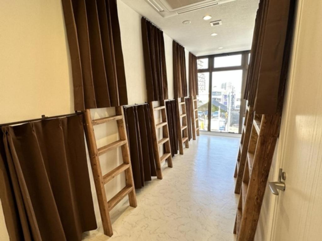 a hallway with a row of black curtains and a door at Monarch Hotel - Vacation STAY 42994v in Otaru