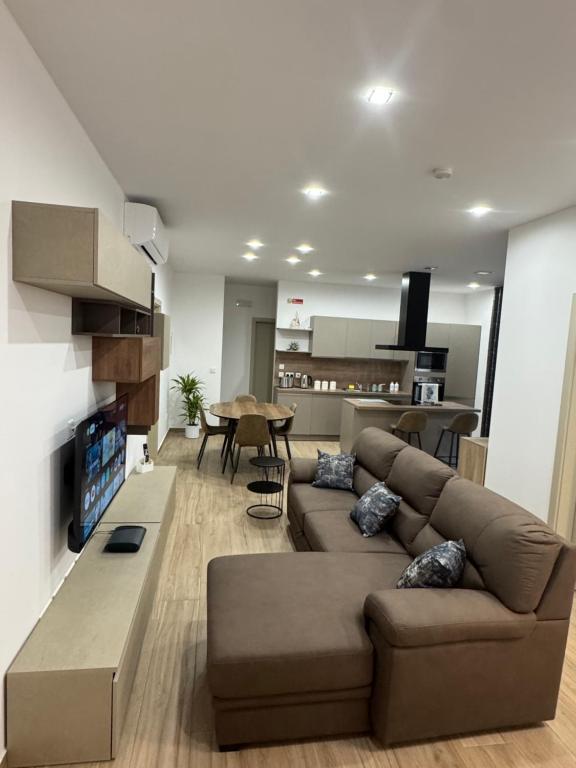 a living room with a couch and a table at Varka Holiday Apartment - Modern Family Friendly and Accessible for All in Marsaxlokk
