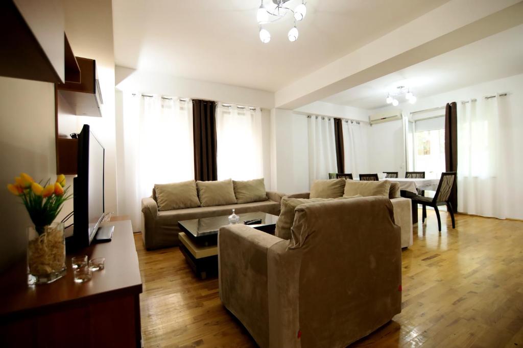 a living room with a couch and a table at Lux Apartment in Kumanovo