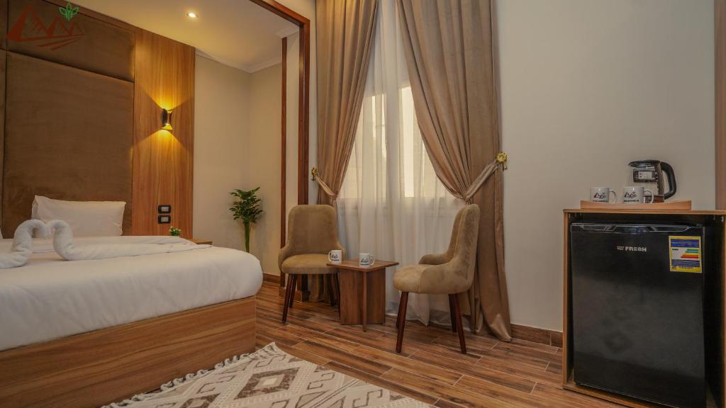 Postel nebo postele na pokoji v ubytování Suzana Pyramids hotel