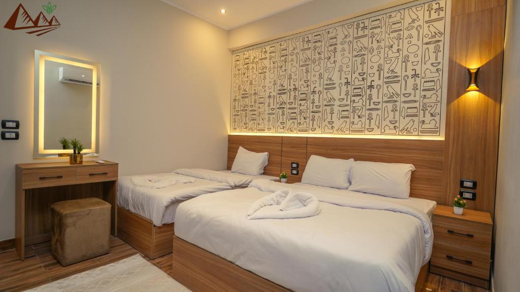 Postel nebo postele na pokoji v ubytování Suzana Pyramids hotel