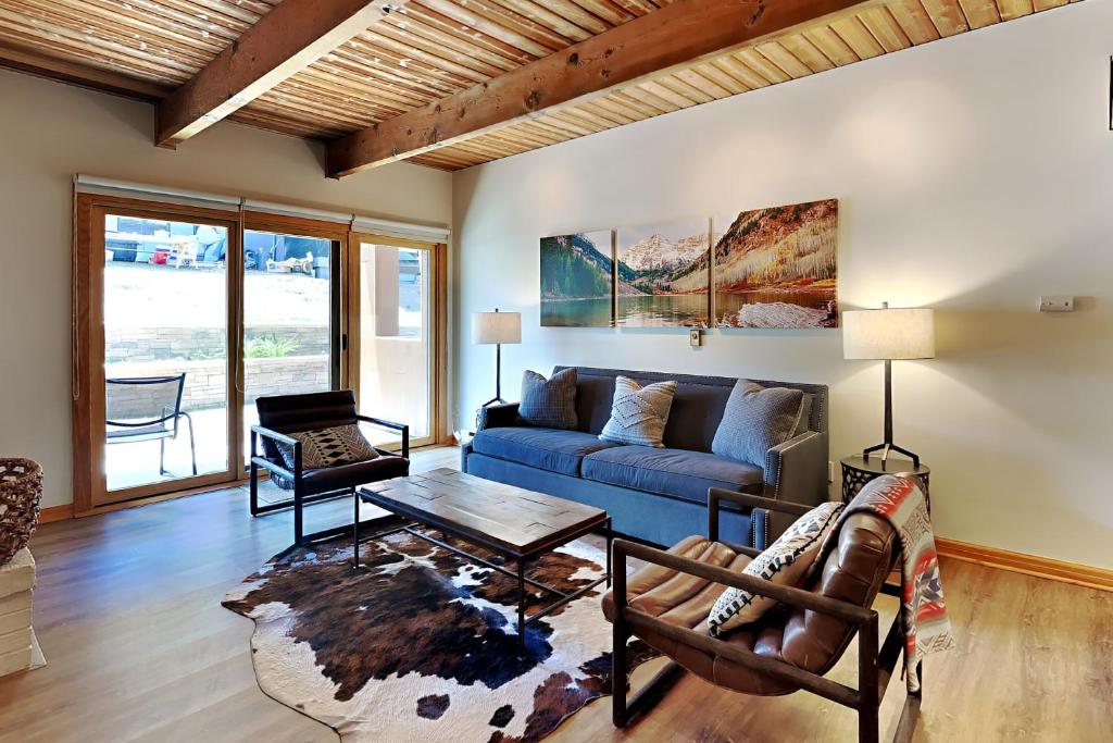 a living room with a blue couch and a table at Timberline Condominiums 1 Bedroom Premier Unit D2F in Snowmass Village