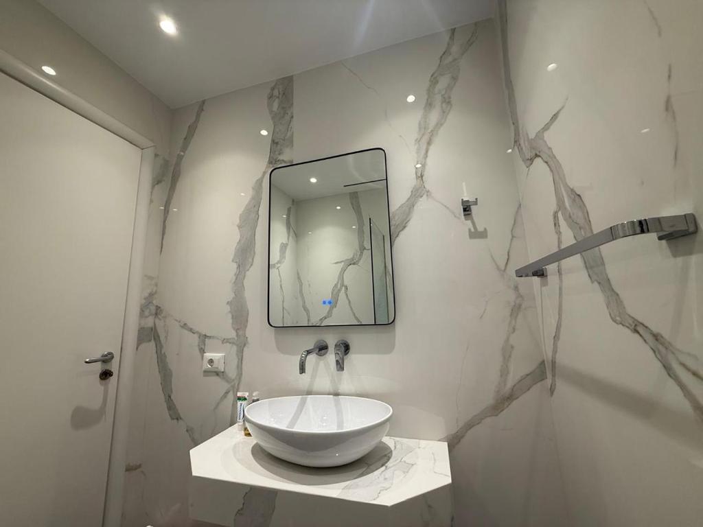 a bathroom with a sink and a mirror at The Blue Horizon in Vlorë