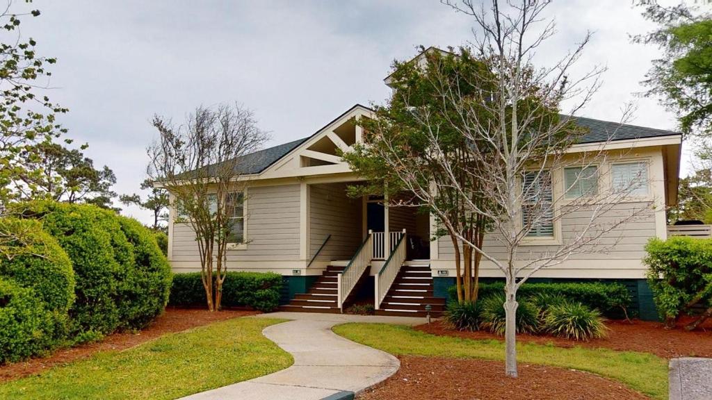 a white house with a pathway in front of it at Lake Views, 2BR, 2BA, Lakeside Villa in Pawleys Island
