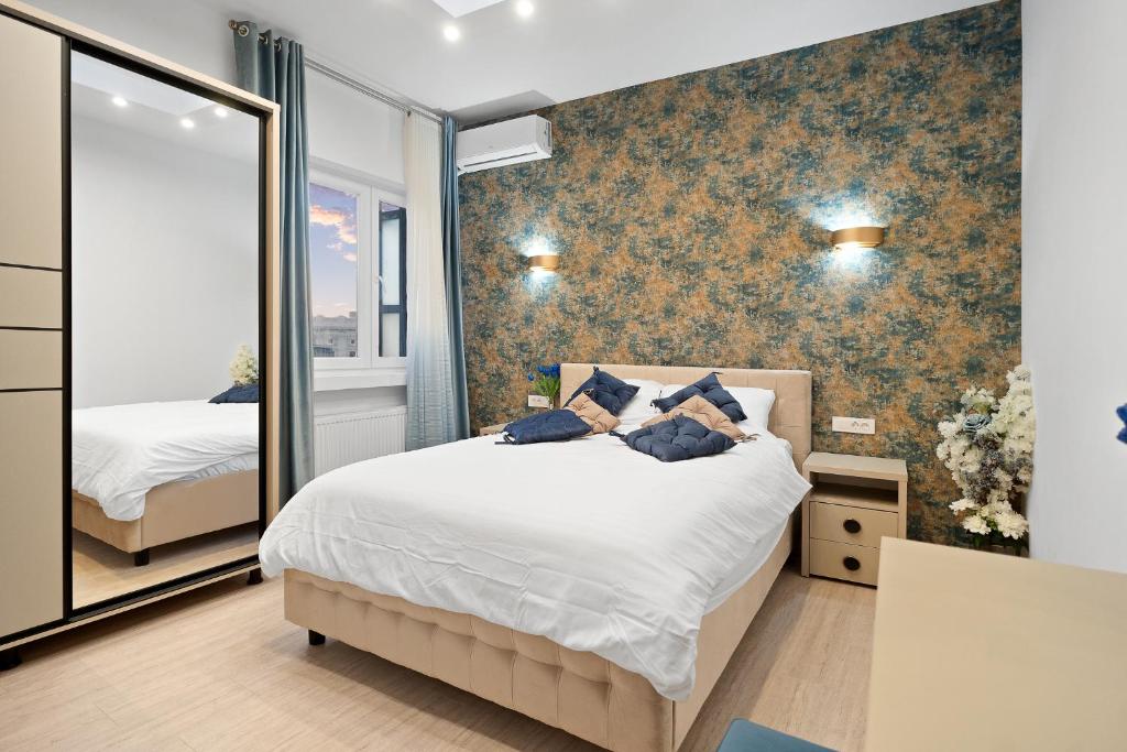 a bedroom with a bed and a large mirror at Victoriei Avenue Gem in Bucharest