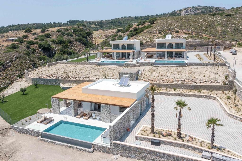 an aerial view of a house with a swimming pool at Athoros Luxury Villas in Afantou