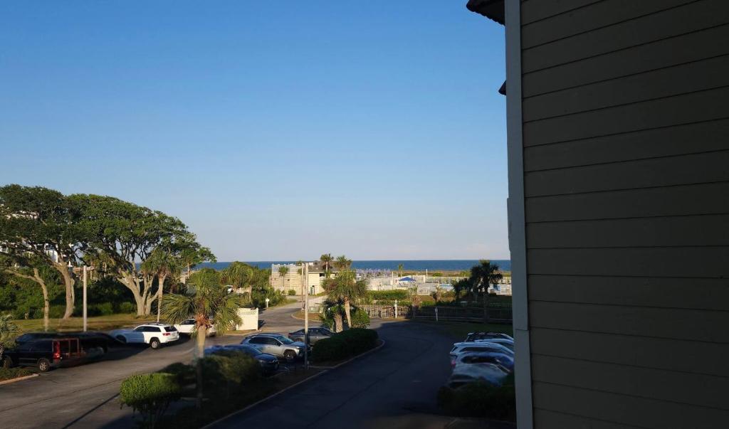 a view of a street with cars parked in a parking lot at Southern Serenity, an HHI Beachfront Resort in Hilton Head Island