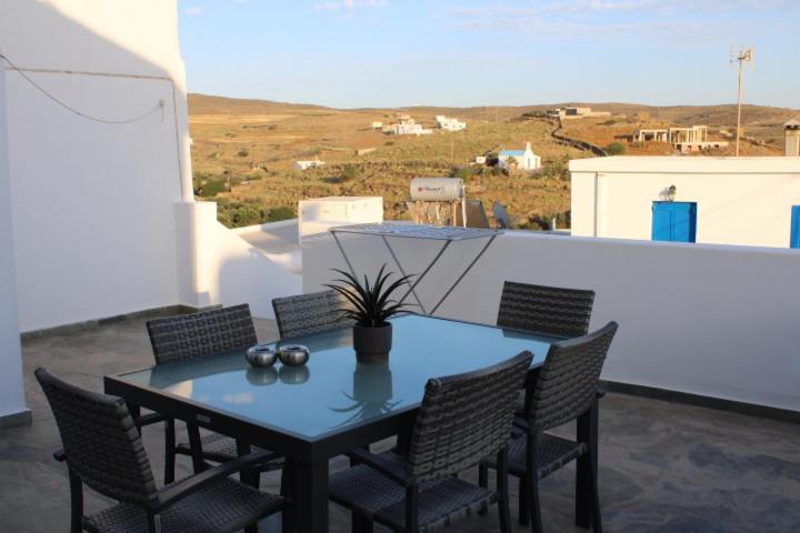 a black table and chairs on a balcony with a view at Family- House in Chora, kythnos in Kithnos