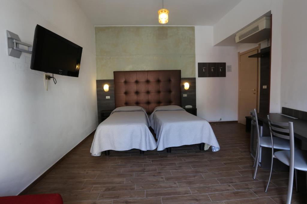 Postel nebo postele na pokoji v ubytování Hotel Piola