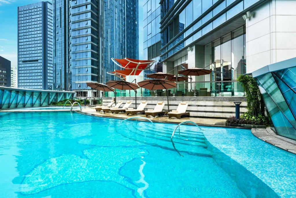 a swimming pool with a shark in a city at The St. Regis Chengdu in Chengdu