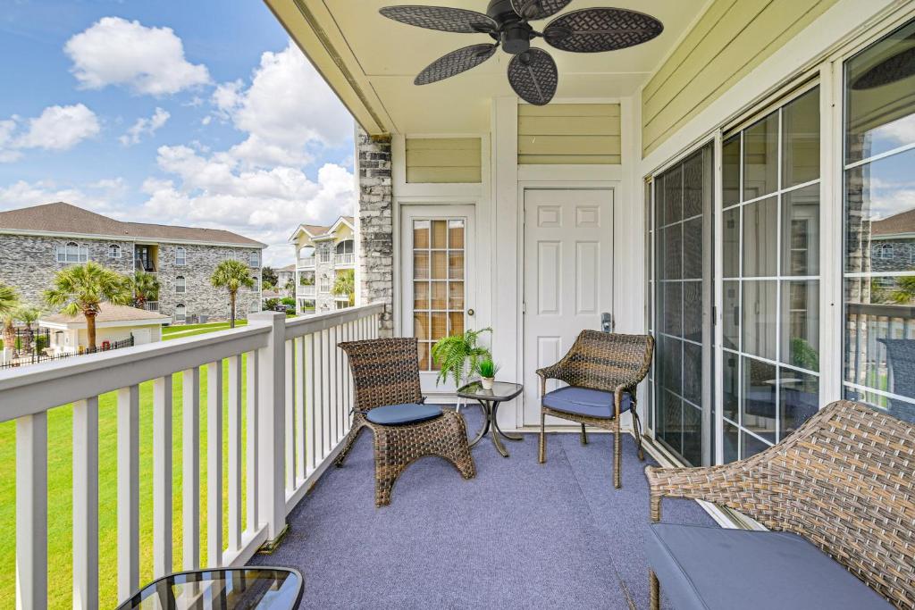 a porch with chairs and a ceiling fan at 2 Mi to Beach Pool-View Myrtle Beach Escape! in Myrtle Beach