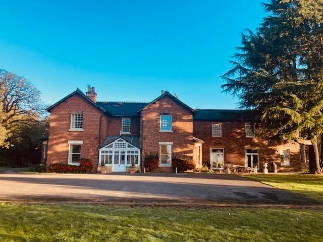 a large brick house with a road in front of it at The Annexe at North Clifton Hall in North Clifton