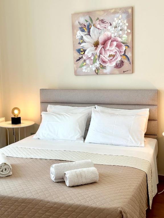a bedroom with a bed with two towels on it at CityCenter Apartment in Argostoli